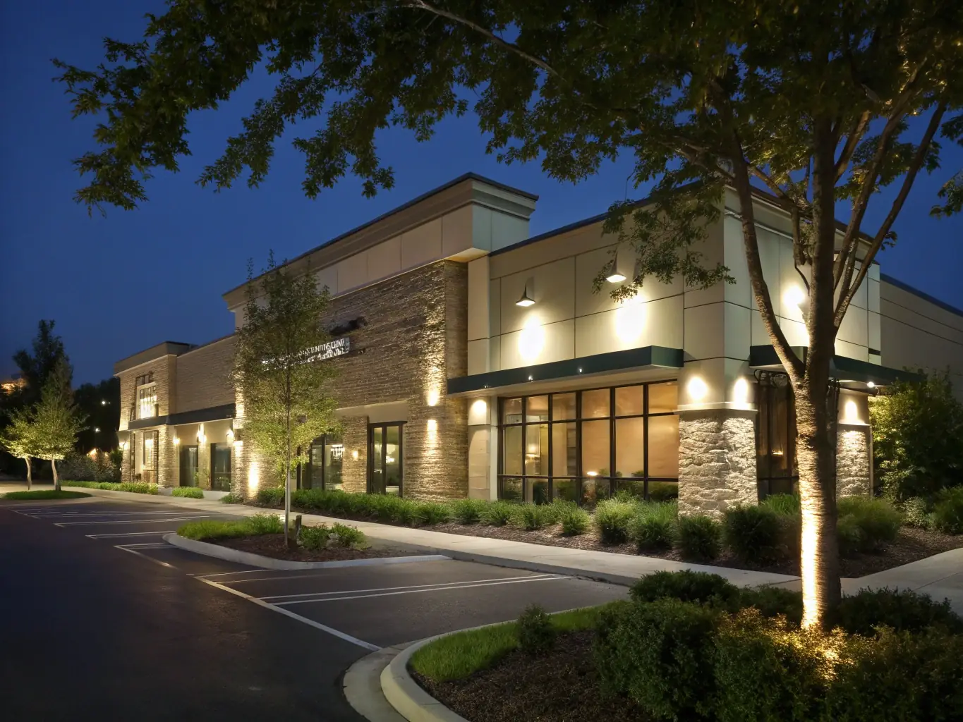 A commercial building's exterior at dusk, highlighting the sophisticated lighting and electrical systems installed and maintained by Lamarche Electric Inc.